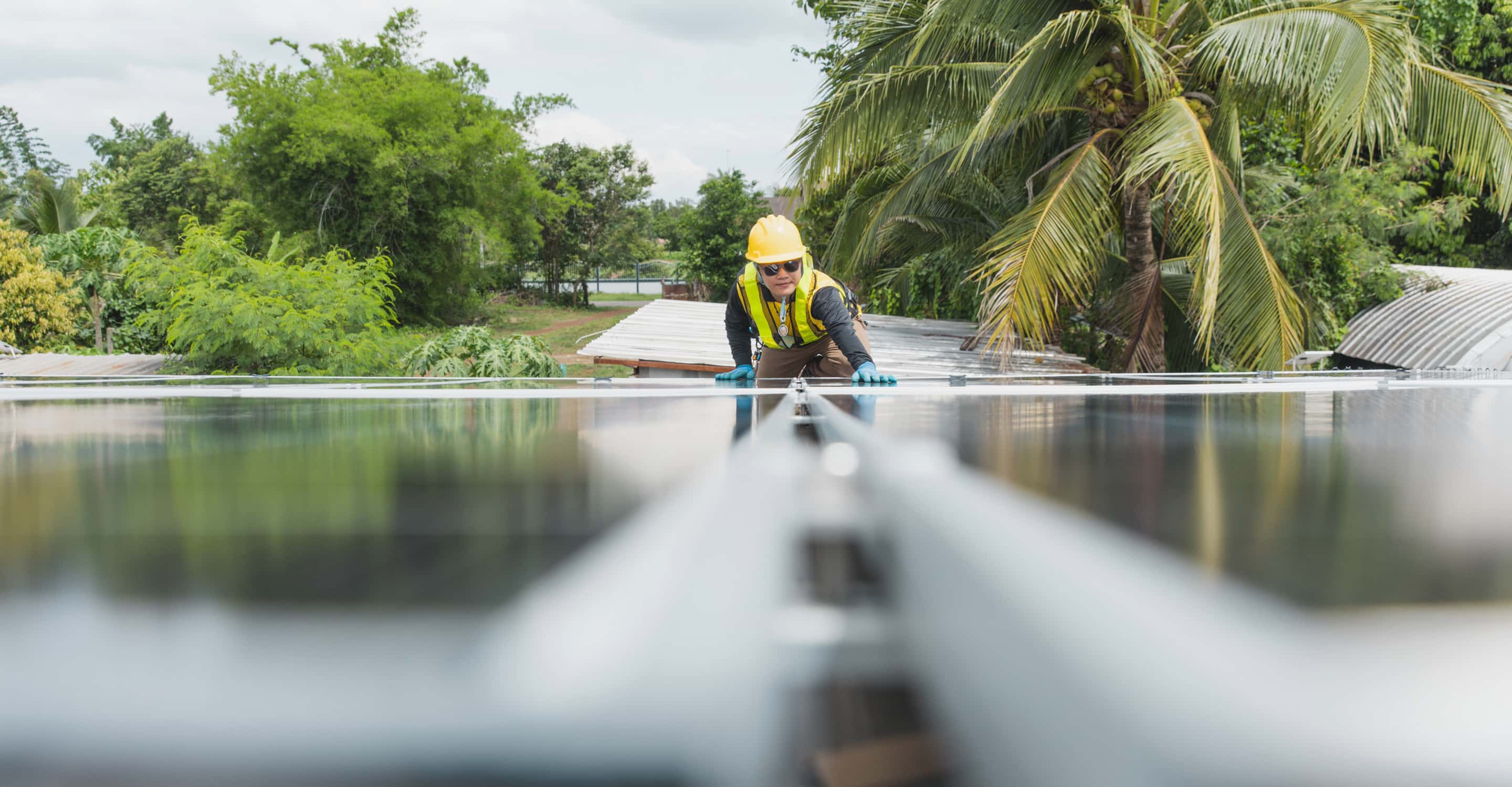 A worker installing rooftop solar panels